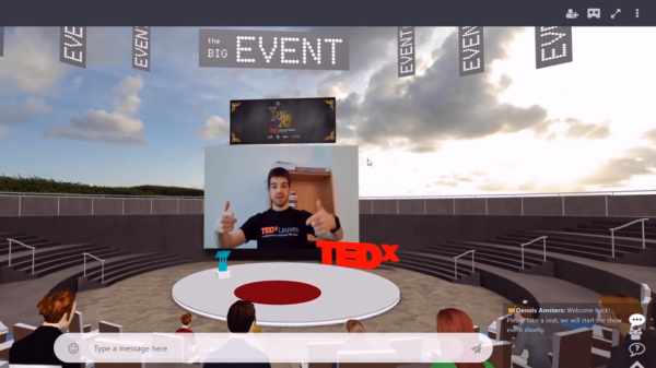 A live speaker on screen at a TEDx event in MootUp