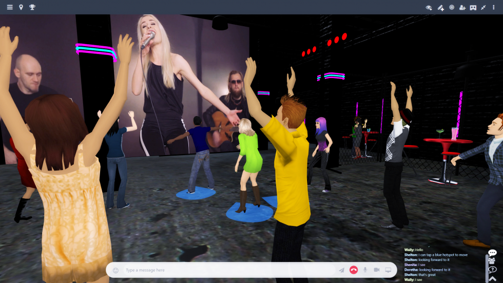 Avatars dancing to live music on the big screen in a MootUp lounge