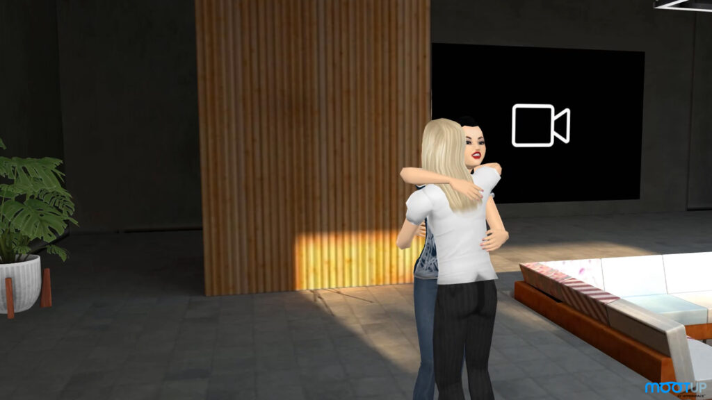 Two avatars hug each other in a realistic representation of human emotion within the virtual Basis Health environment in the MootUp metaverse